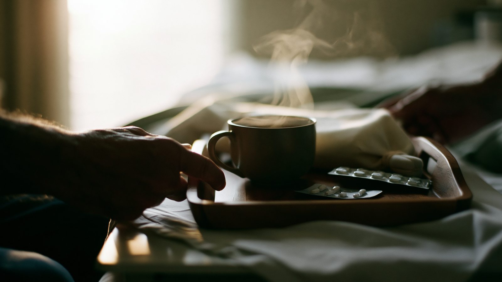 Partner setting period dizziness comfort within reach: warm drink and water on a tray by the bed